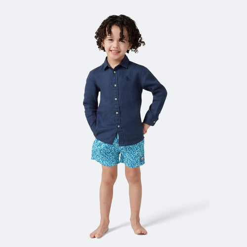 Blue patterned swim shorts with a brand logo on a white background